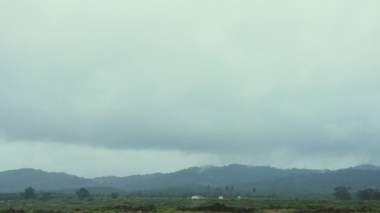 mountain, sky, scenics, tranquil scene, tranquility, beauty in nature, cloud - sky, landscape, weather, cloudy, nature, fog, overcast, mountain range, non-urban scene, idyllic, tree, cloud, foggy, outdoors