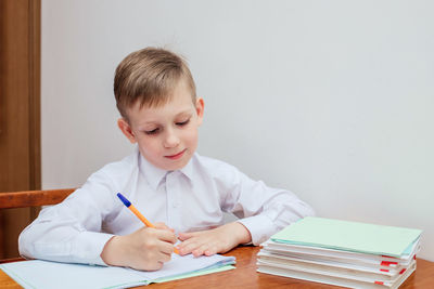 Boy sitting on table