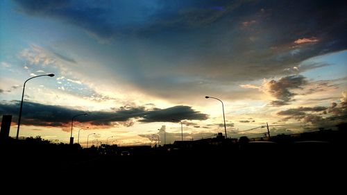 Silhouette of trees against dramatic sky