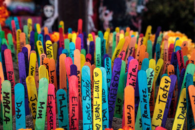 Close-up of text on colorful sticks