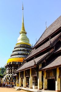 Low angle view of pagoda against clear blue sky