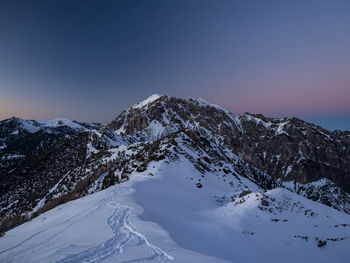 Scenic view of snowcapped mountains against clear sky