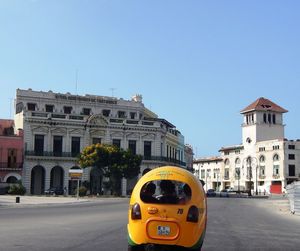 Yellow car on road against clear sky