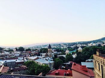 High angle view of houses in town against clear sky