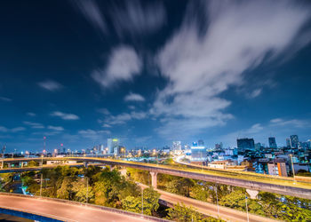 High angle view of illuminated cityscape against sky at night