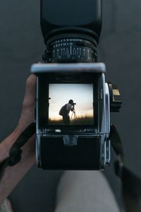 Close-up of woman photographing with camera
