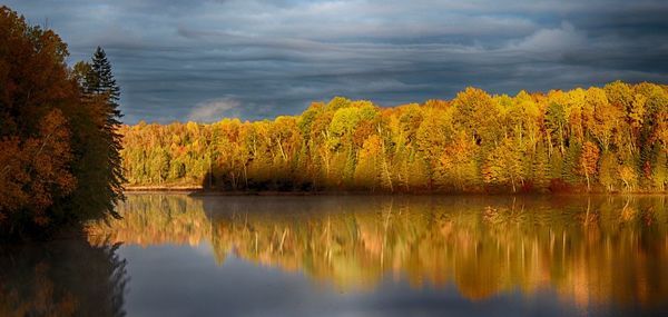 Scenic view of lake against sky during sunset