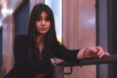 Portrait of a young woman standing with eyes closed