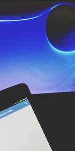 Airplane wing against clear blue sky at night