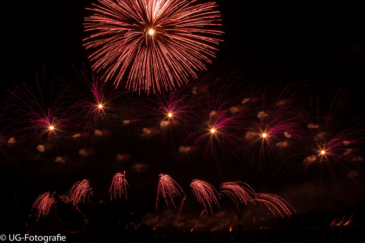 illuminated, night, firework display, celebration, arts culture and entertainment, long exposure, exploding, firework - man made object, motion, event, glowing, blurred motion, multi colored, sparks, low angle view, entertainment, firework, sky, celebration event, fire - natural phenomenon