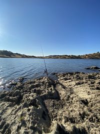 Scenic view of beach against clear blue sky