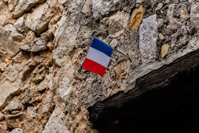 Low angle view of flag on rock