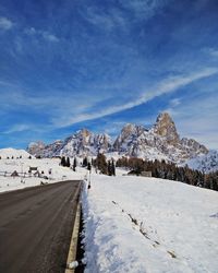 Scenic view of snowcapped mountains against blue sky