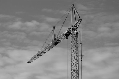 Low angle view of crane against sky