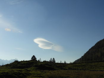 Low angle view of land against blue sky