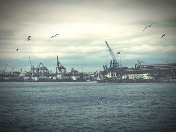 View of harbor against cloudy sky