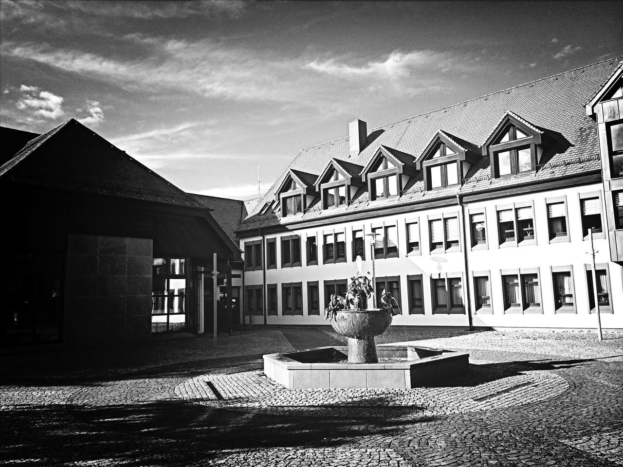 architecture, building exterior, built structure, sky, chair, house, cloud - sky, sunlight, cloud, absence, residential structure, day, table, outdoors, residential building, shadow, grass, empty, window, no people