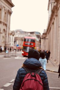 Rear view of people walking on street