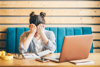 Young woman using laptop on table