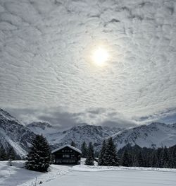 Scenic view of snowcapped mountains against sky during sunset