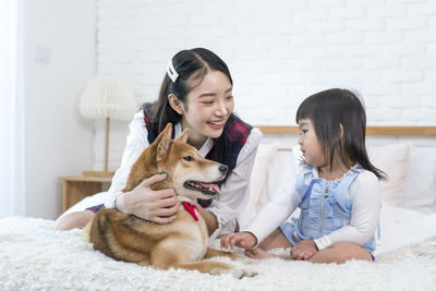 Siblings sitting on floor