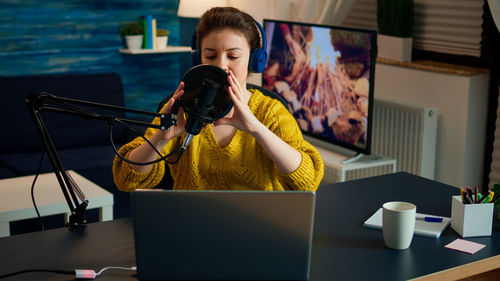 Woman playing game at home