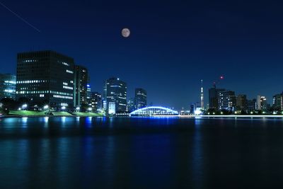 Illuminated city at waterfront