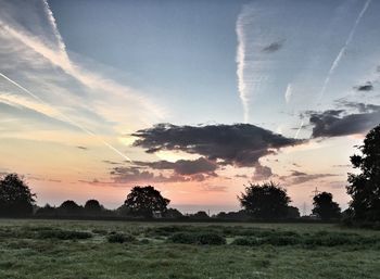 Scenic view of field against sky at sunset