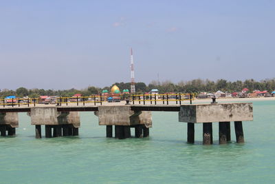 View of pier on river against sky