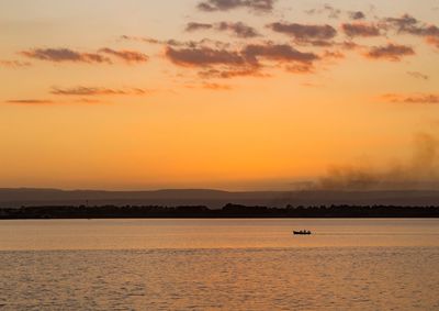 Scenic view of sea against orange sky