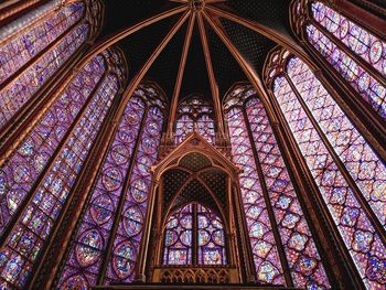 Low angle view of ornate glass window of building