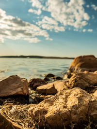 Rocks on beach against sky