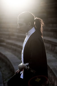 Side view of woman standing on steps