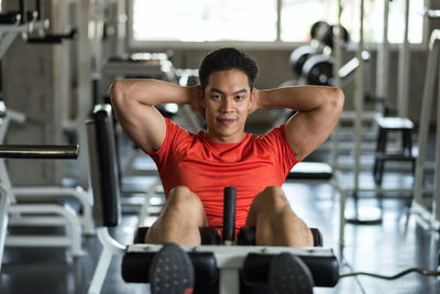 Young woman exercising in gym