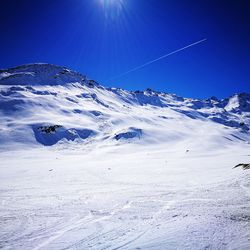 Snow covered landscape against sky