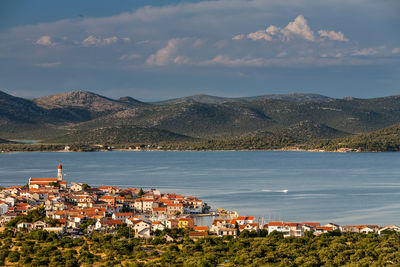 Townscape by sea against sky