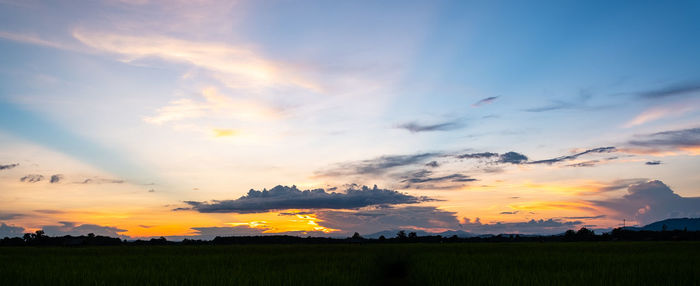 Scenic view of silhouette field against sky during sunset