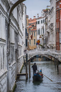 Gondola on narrow canal in venice