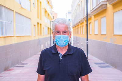Portrait of man standing against wall