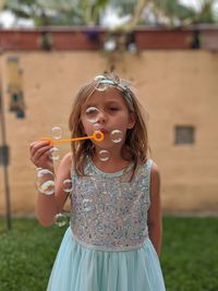 Portrait of a girl holding bubbles