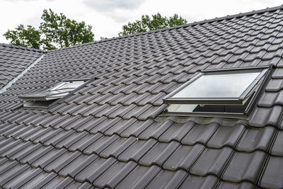 Low angle view of roof and building against sky