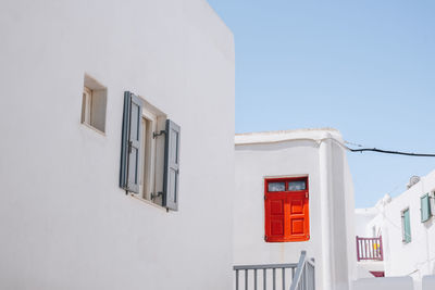 Traditional whitewashed houses with red details in mykonos town, mykonos, greece.