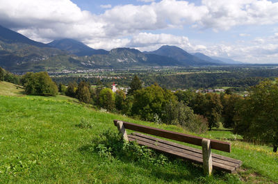 Scenic view of green landscape and mountains against sky