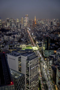 Illuminated cityscape against sky at night