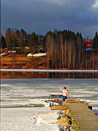 Rear view of woman sitting in water