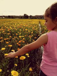 Midsection of woman on field against sky