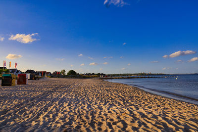 Scenic view of beach against blue sky