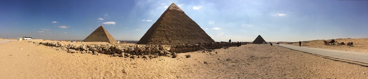 Pyramids at desert against sky