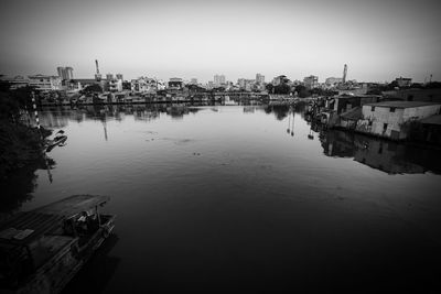 High angle view of buildings by river against sky