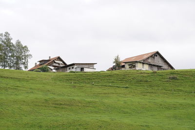 Houses on field against sky